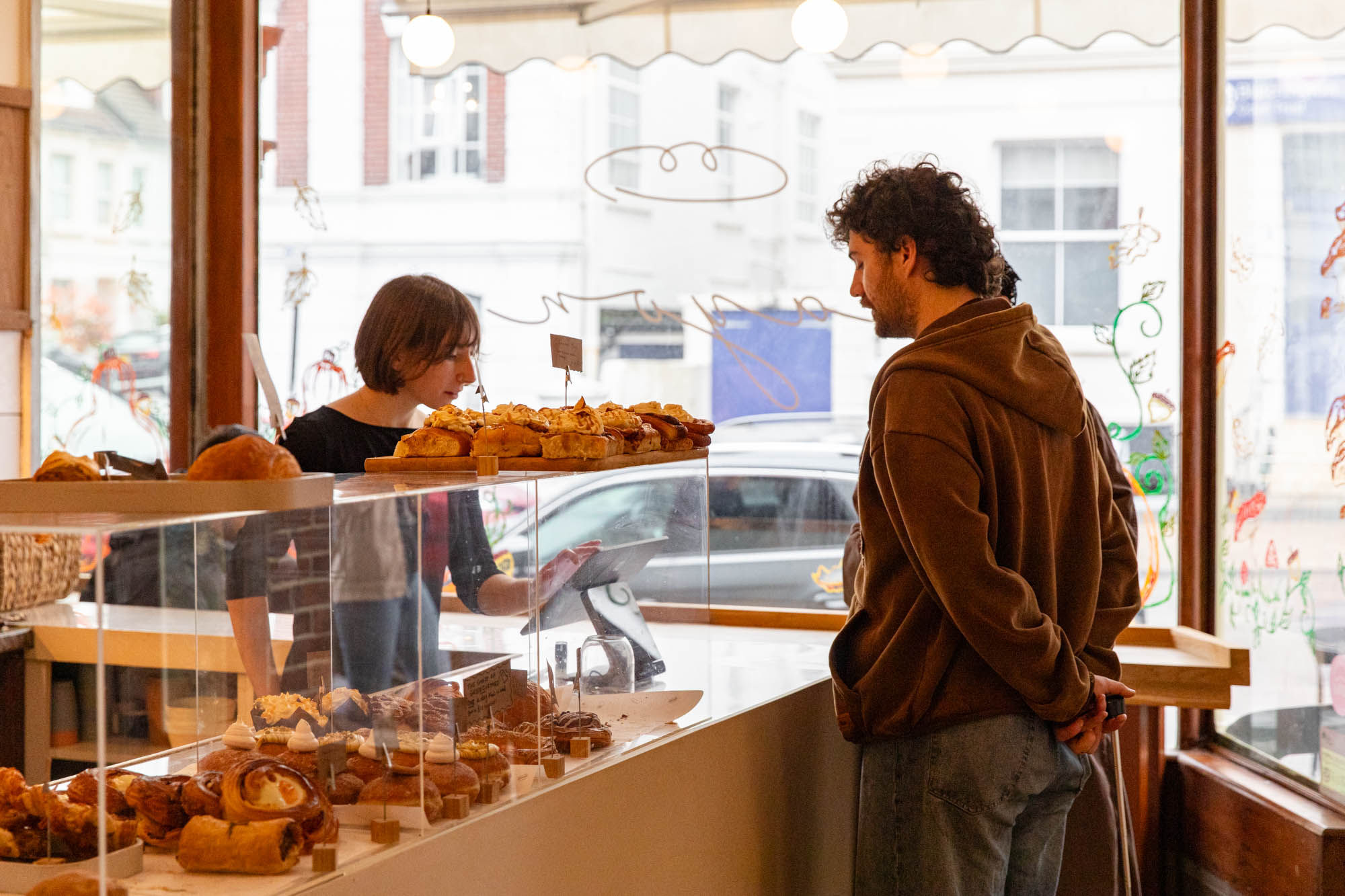 a man looking at the pastry 