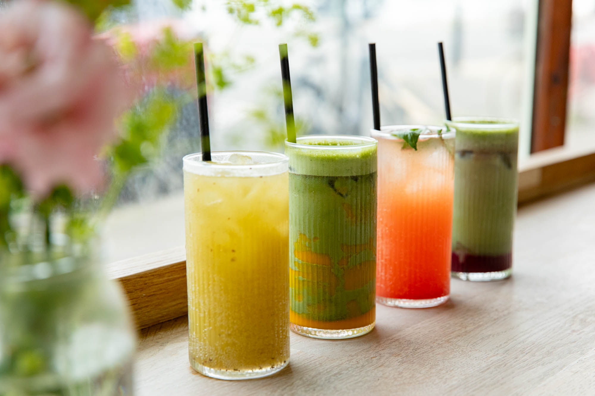 4 different non alcoholic drinks on the window table at Bayon Bakery