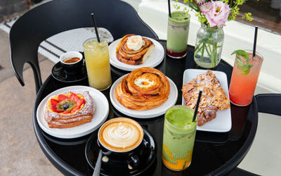 Bayon Bakery, over head shot of the black table in front of the venue laid out with various pastries and cocktails