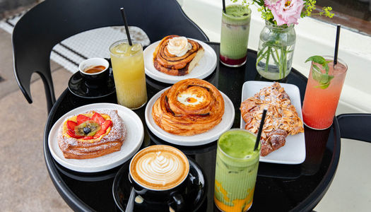 Bayon Bakery, over head shot of the black table in front of the venue laid out with various pastries and cocktails