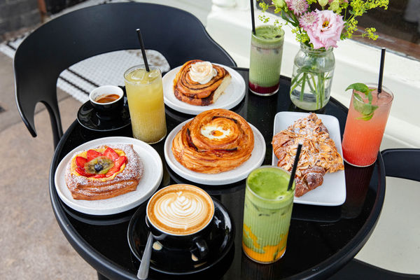 Bayon Bakery, over head shot of the black table in front of the venue laid out with various pastries and cocktails