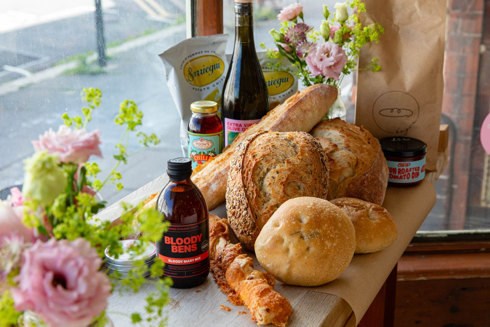 couple of breads in the corner with drink bottles