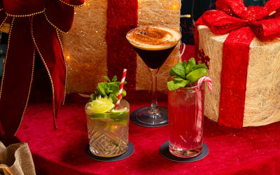 three cocktails with the festive background next to each other