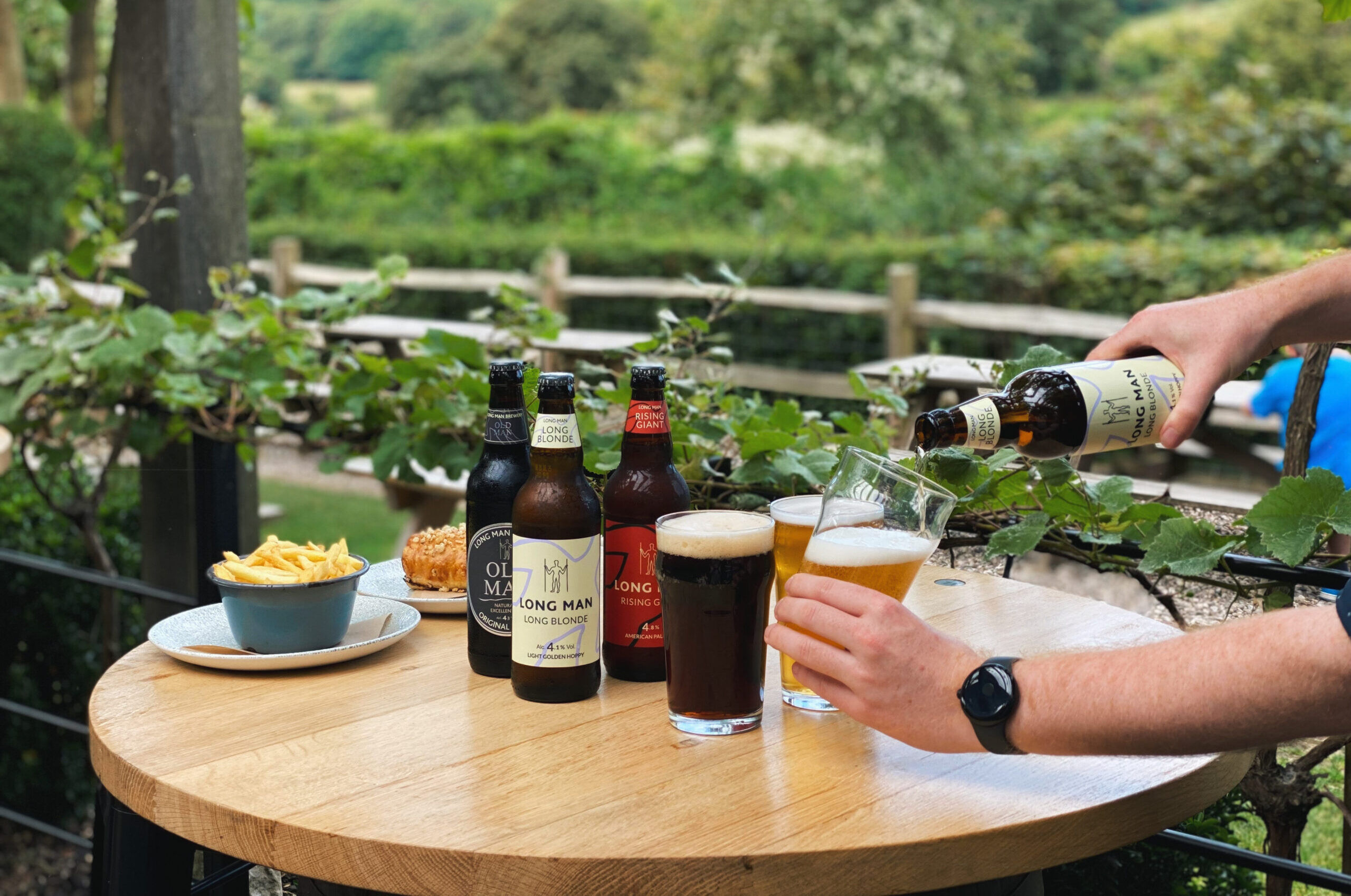 person pouring beers on the table
