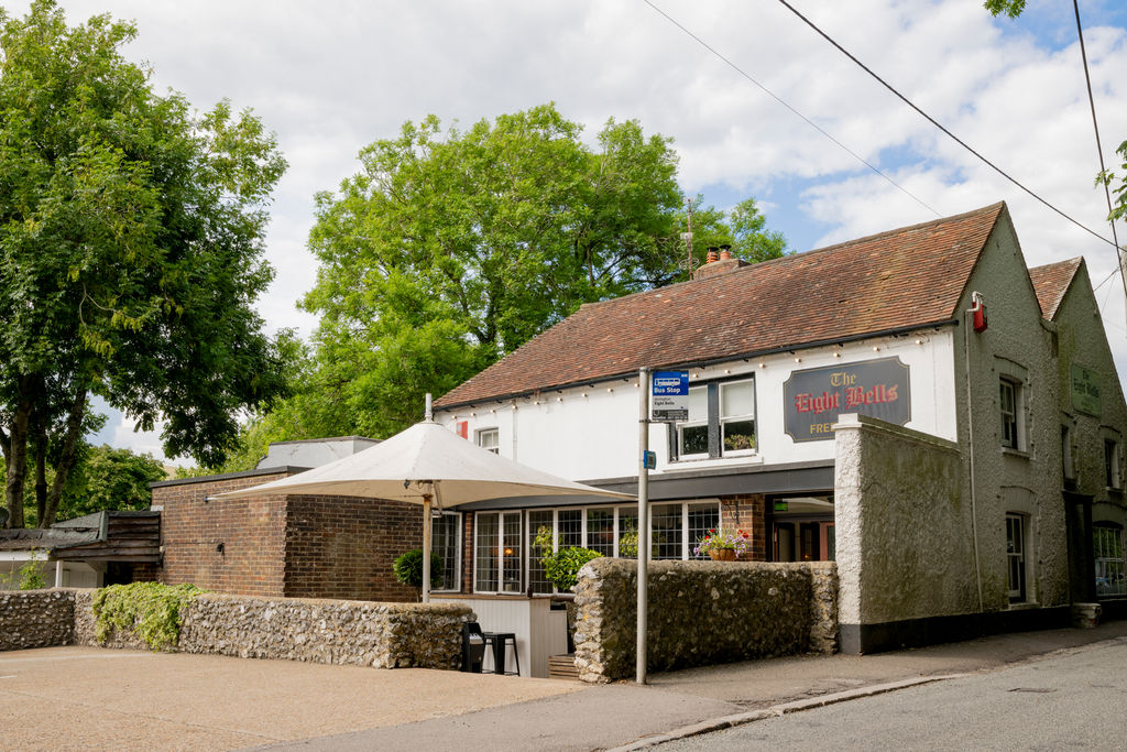 Exterior of country pub with leafy trees on a summers day.
