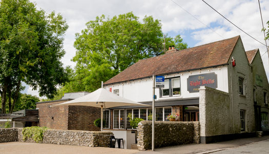 Exterior of country pub with leafy trees on a summers day.