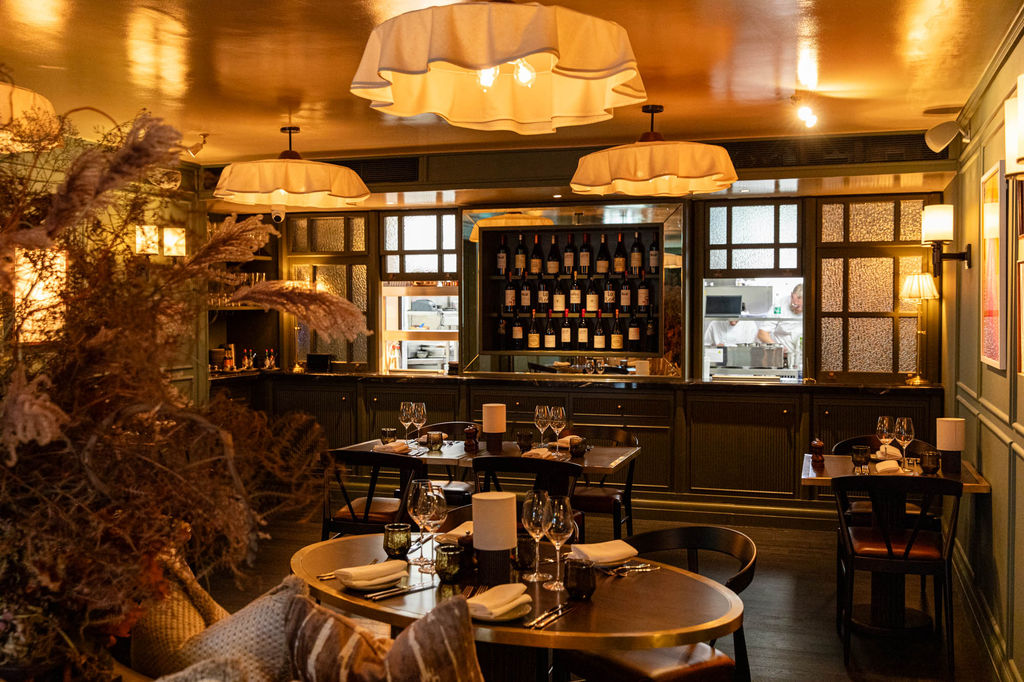 interior shot of the Pearly Cow - dim lights and wooden furniture