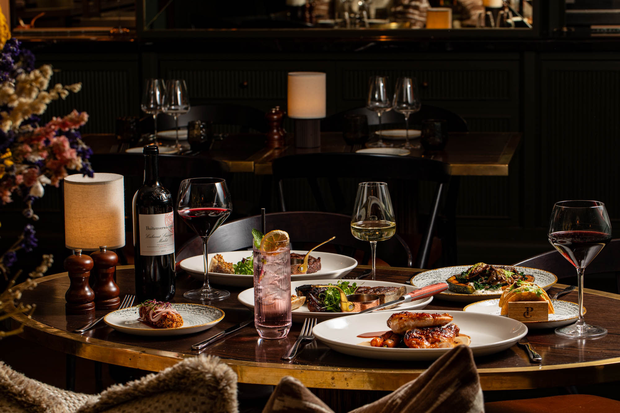 side shot of the table laid out with dishes and drinks at Pearly Cow Brighton