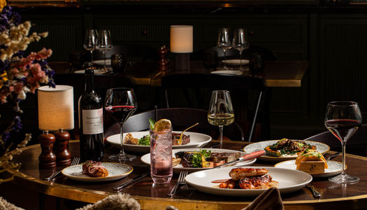 side shot of the table laid out with dishes and drinks at Pearly Cow Brighton