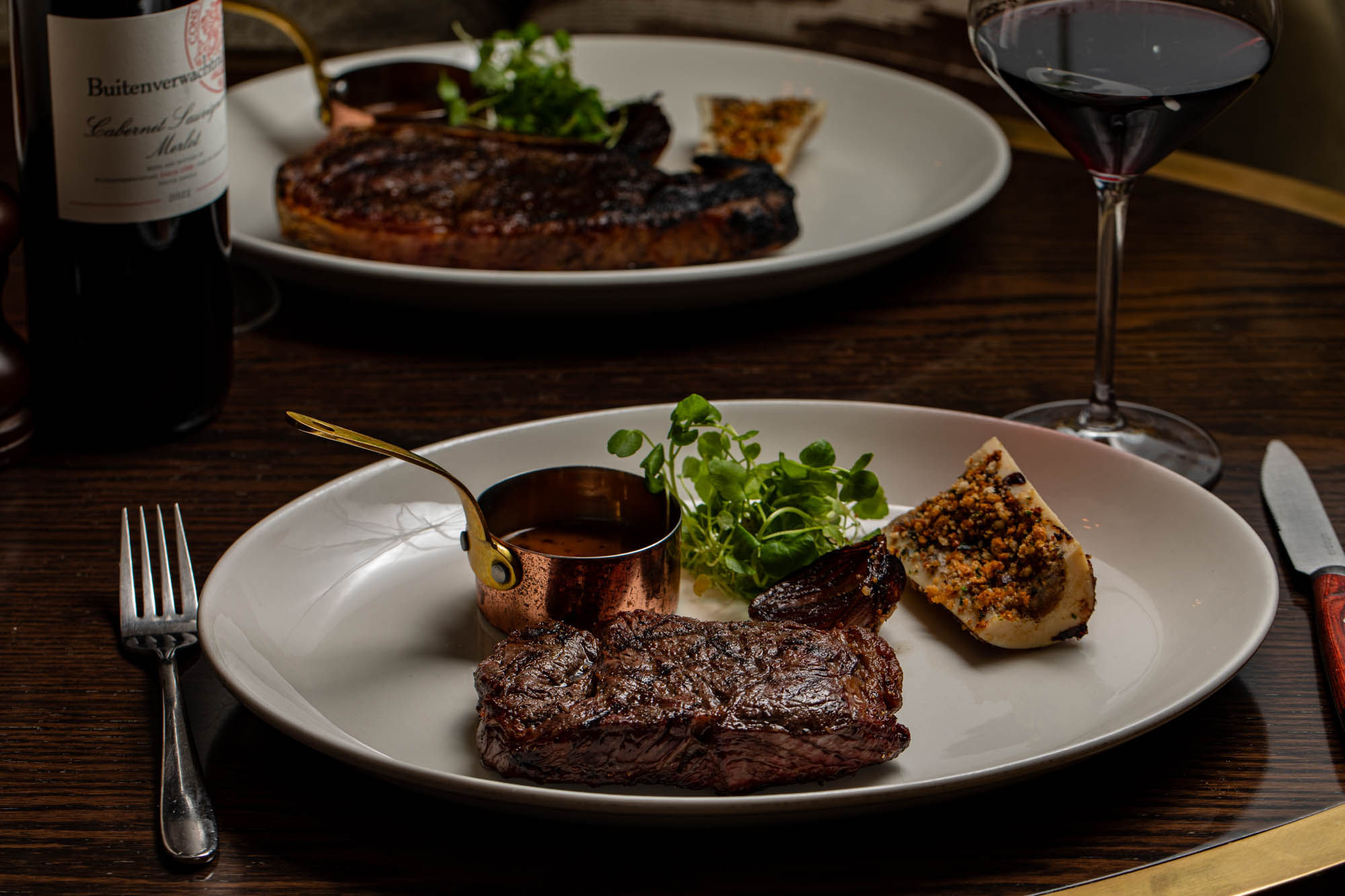 two steak dishes served on the table