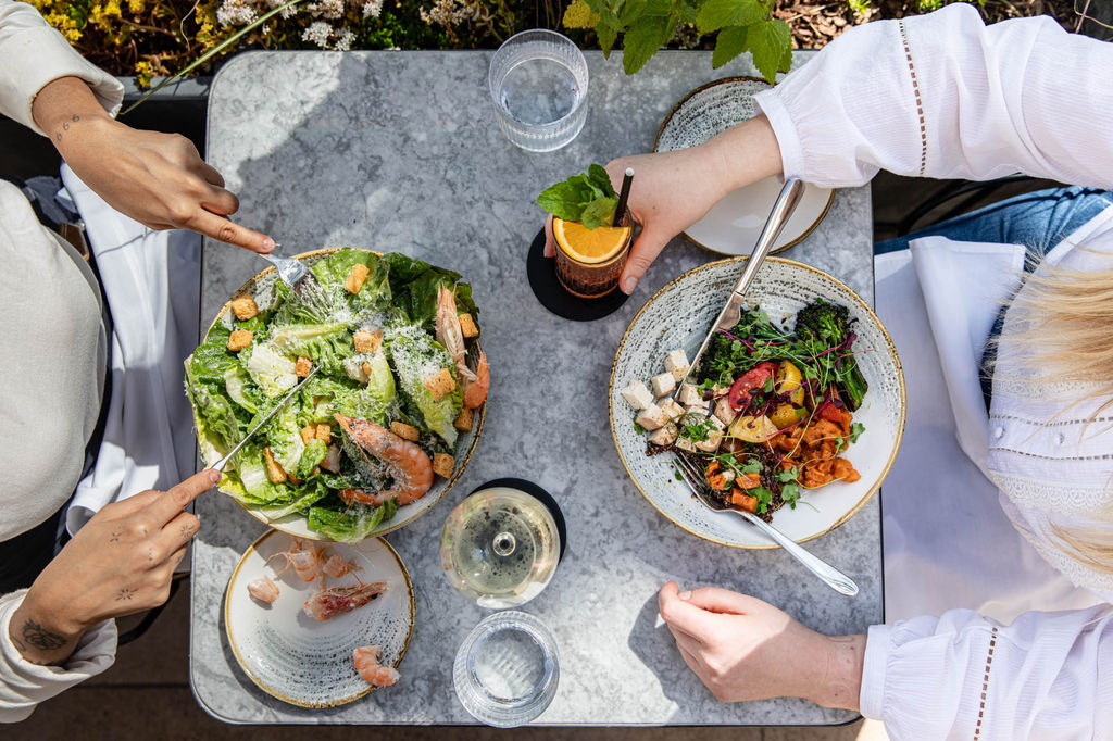 over head shot of the table laid out with small plates and drinks at the Pearly Cow