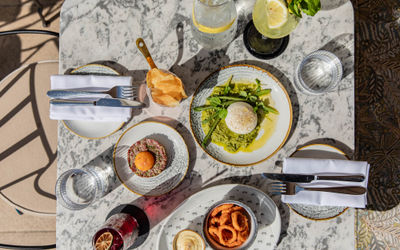 over head shot of the table laid out with small plates and drinks at the Pearly Cow