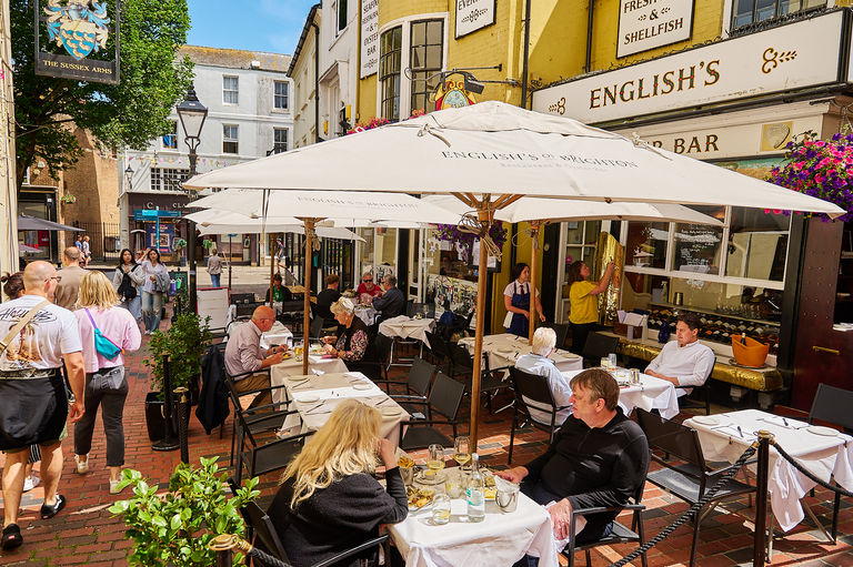 exterior shot of terrace at English's of Brighton populated with people enjoying their food and drinks
