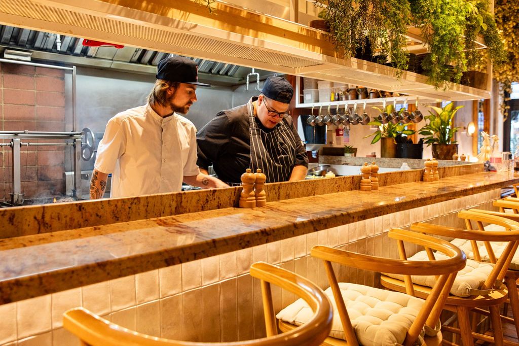 open kitchen at the Kindling brighton showcasing two chef preparing a meal