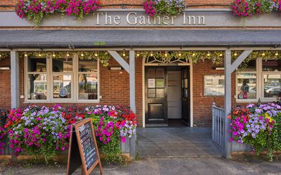 exterior shot of the Gather Inn pub and restaurant - plenty of colorful flowers covering the venue
