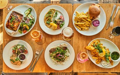 over head shot of the table laid out with six different dishes and few drinks at the Gather Inn