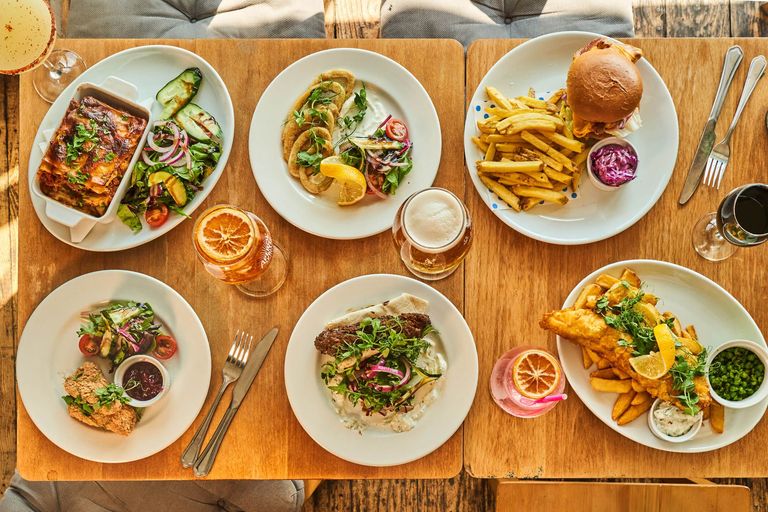 over head shot of the table laid out with six different dishes and few drinks at the Gather Inn
