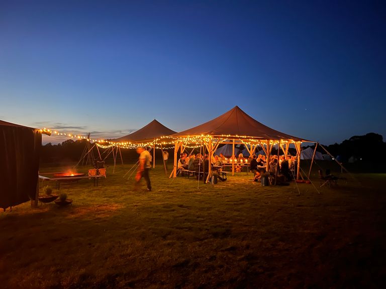The stage is set for an evening event at Woodfire Camping. Known for gastro camping and Brighton restaurant quality food, Woodfire has guest events throughout the whole summer.