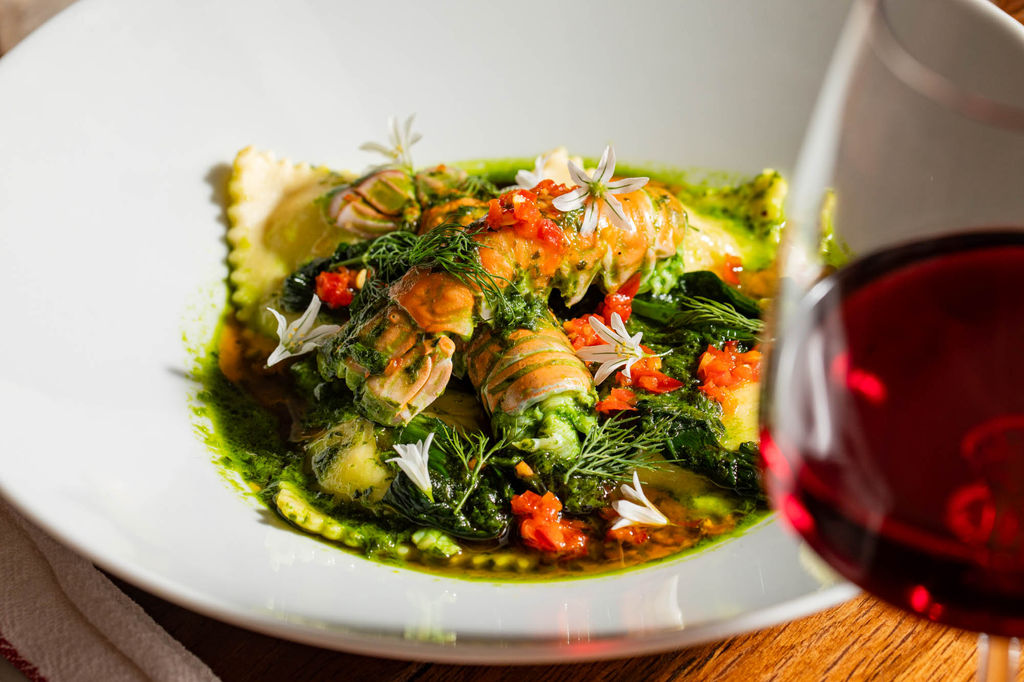 close up shot of raviolli dish with veggies