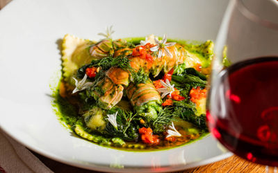 close up shot of raviolli dish with veggies
