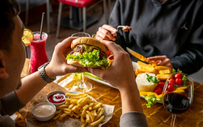 a person holding meat burger at Fogo de Chão Brazilian Steakhouse