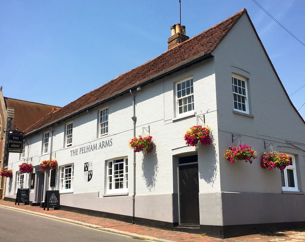 pubs and bars in Lewes Guide. Picture the white facade and high pitched roof of The Pelham Arms.