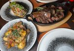 close up shot of the main dishes at Bohemia, including steak, potaotes
