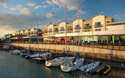 Brighton Marina on a suny evening. Boats in the water and light shining on the restaurants that surround the marina.