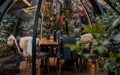 A festive winter igloo with furry blankets and baubles.