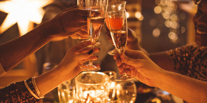 toasting with champagne at a festive new year's eve party around Christmas.