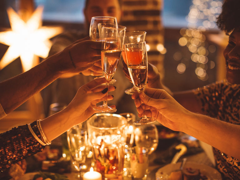 toasting with champagne at a festive new year's eve party around Christmas.