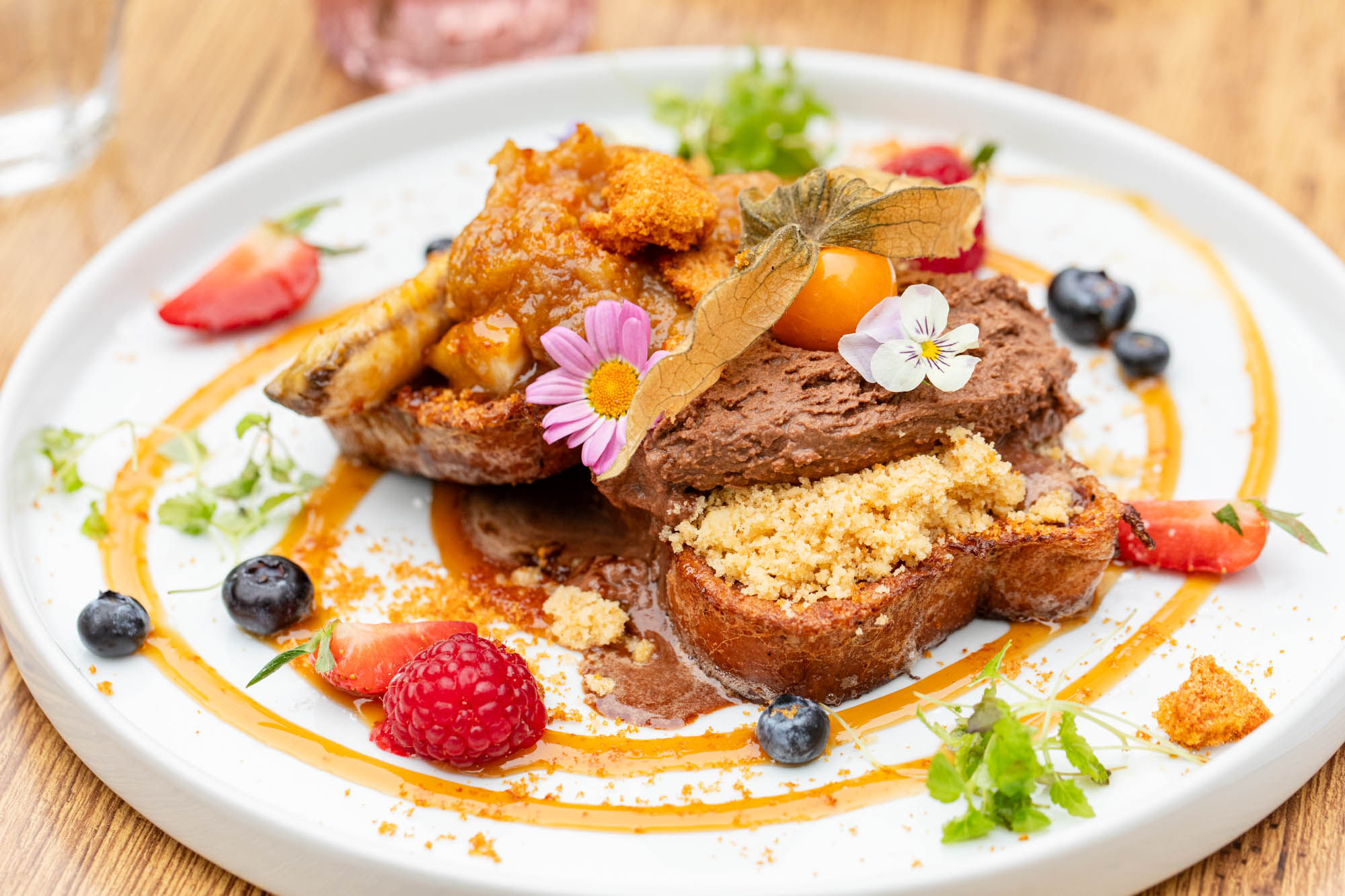 close up shot of the french toast with fruits and chocolate