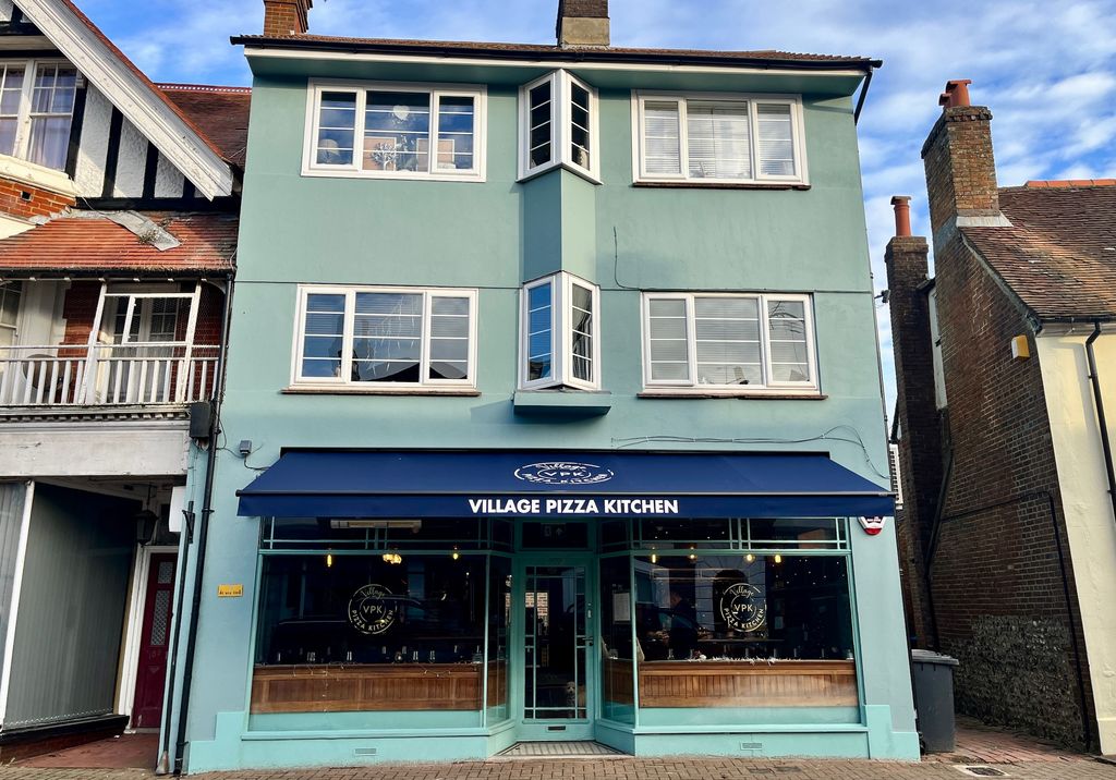 the Village Pizza Kitchen - Hurstpierpoint Restaurant. Facade with different shades of blue.