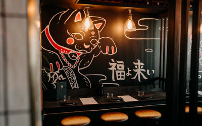 Cat wall art with bar stools at Bonsai Plant Kitchen