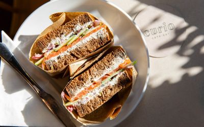 over head close up shot of the two delicious sandwiches served on the plate at Curio Cafe and Bar