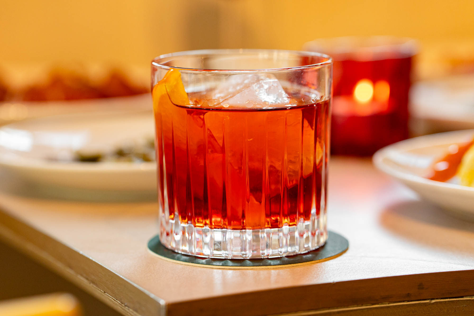 red cocktail with ice cubes
