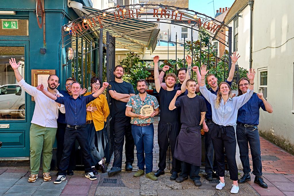 Burnt Orange team shot, celebration of win of the Best Restaurant in Brighton - BRAVO 2025. This Brighton restaurant is located in Brighton's iconic Lanes, the big hospitality team are stood in the Burnt Orange alfresco area