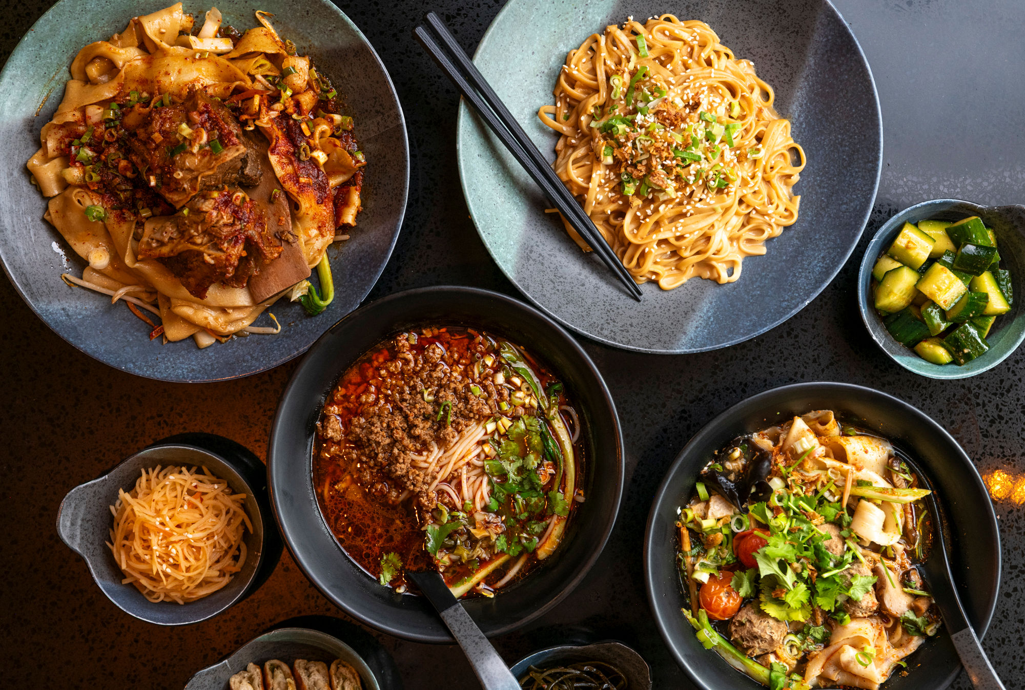 over head shot of the four dishes at Shaaxni Brighton including various types of noodles 
