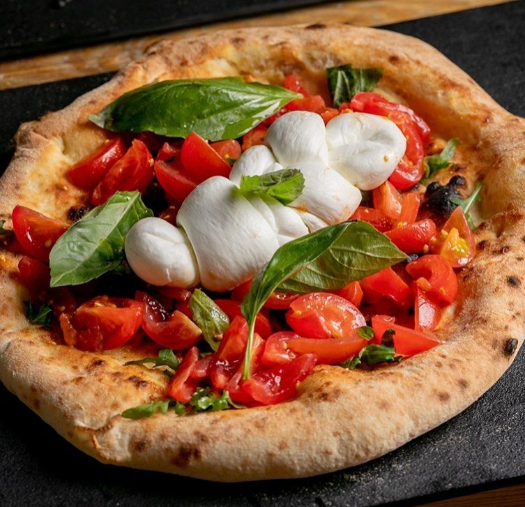 close up shot of pizza with mozzarella. VIP Pizza is located in central Brighton, close to the pier and St Jame's Street