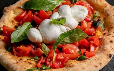 close up shot of pizza with mozzarella. VIP Pizza is located in central Brighton, close to the pier and St Jame's Street
