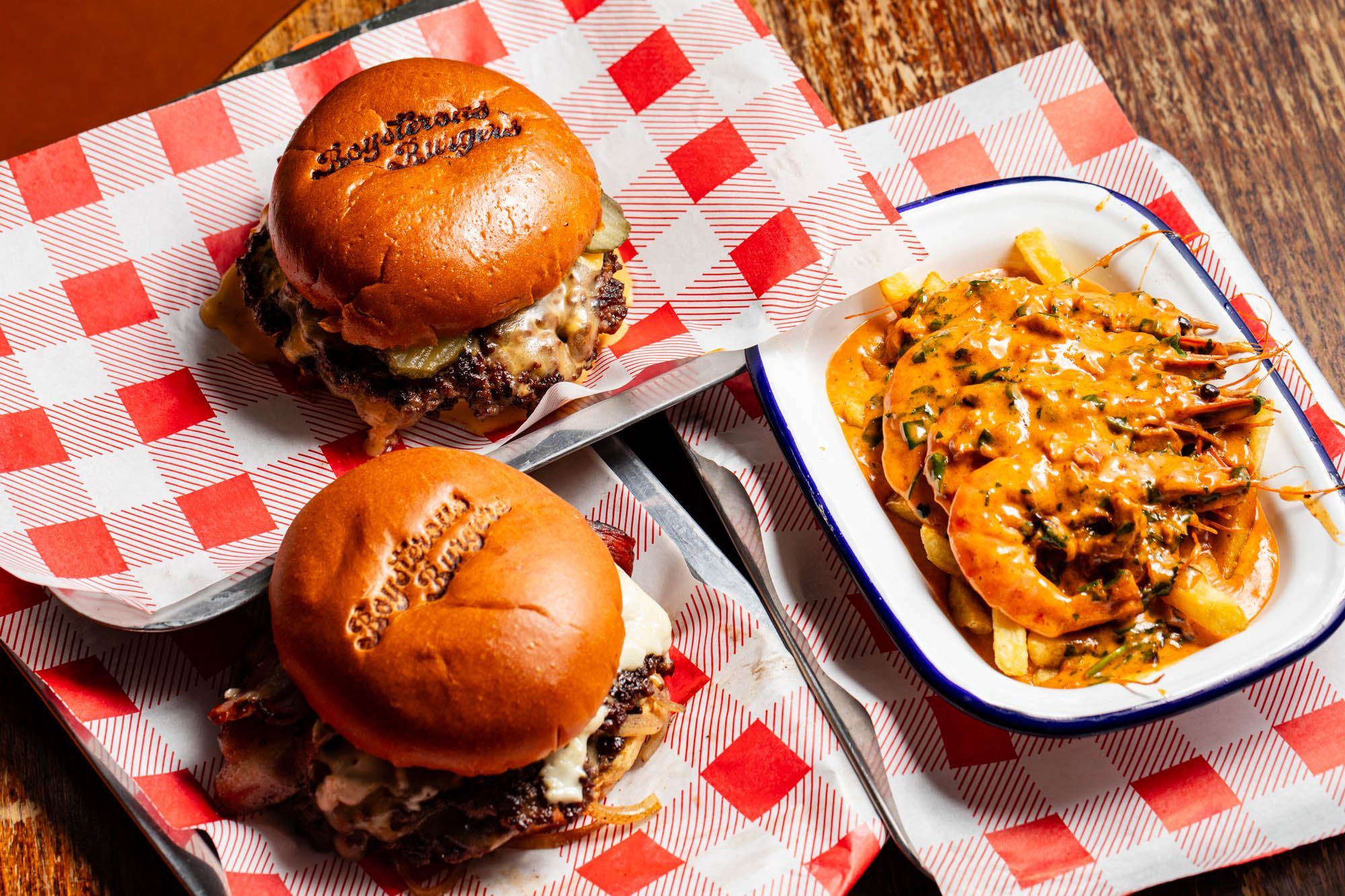two delicious burgers with shrimps on the side at Boysterous Burgers