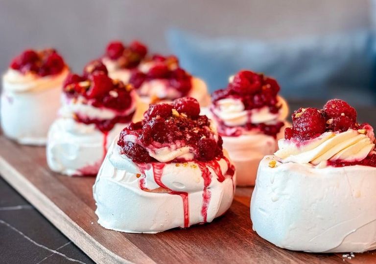 delicious white cake with raspberry on the top of it
