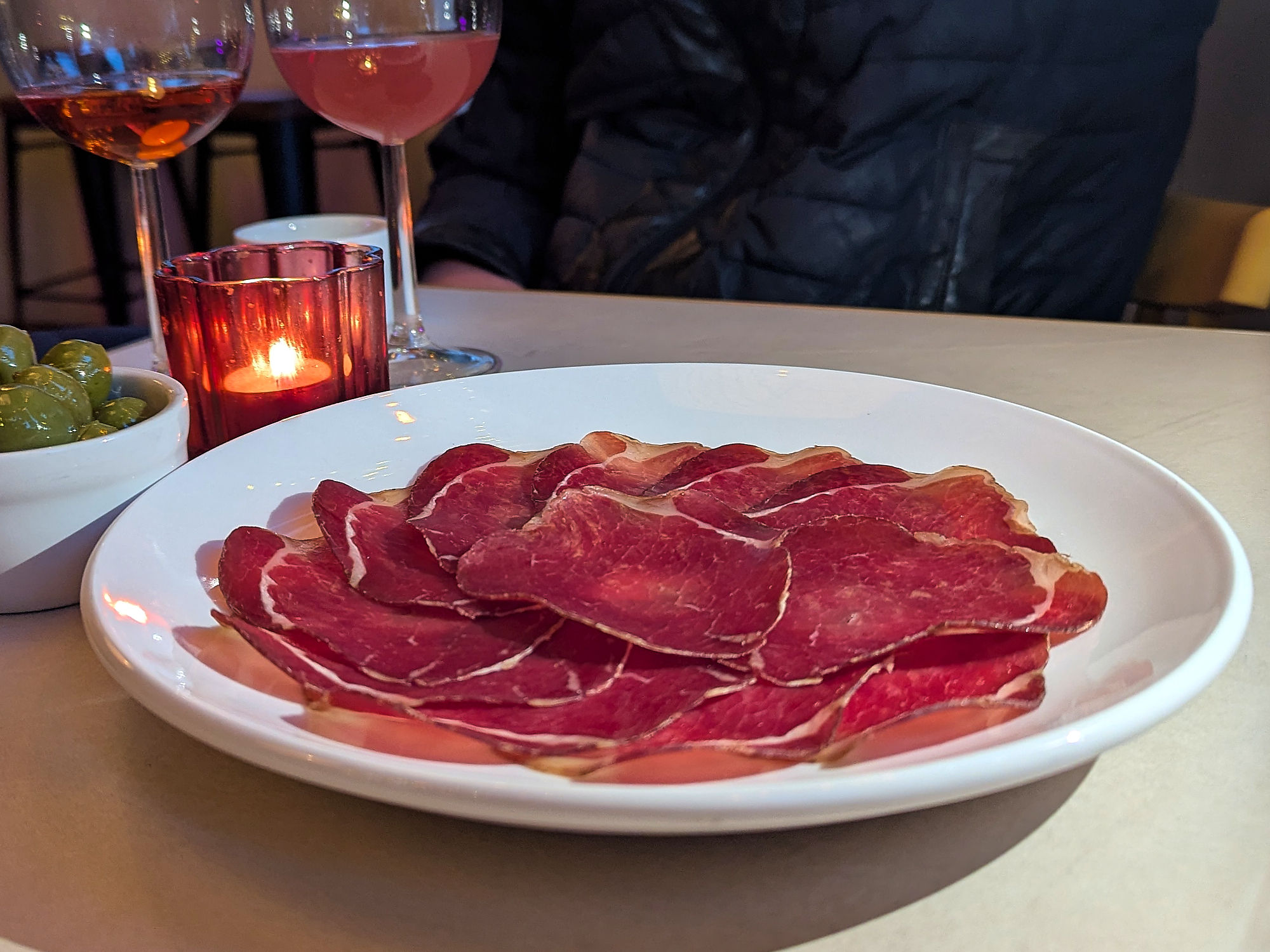 plate of bresaola (cured with grapefruit, bay and spices then soaked in lapsang souchong and kefir)
