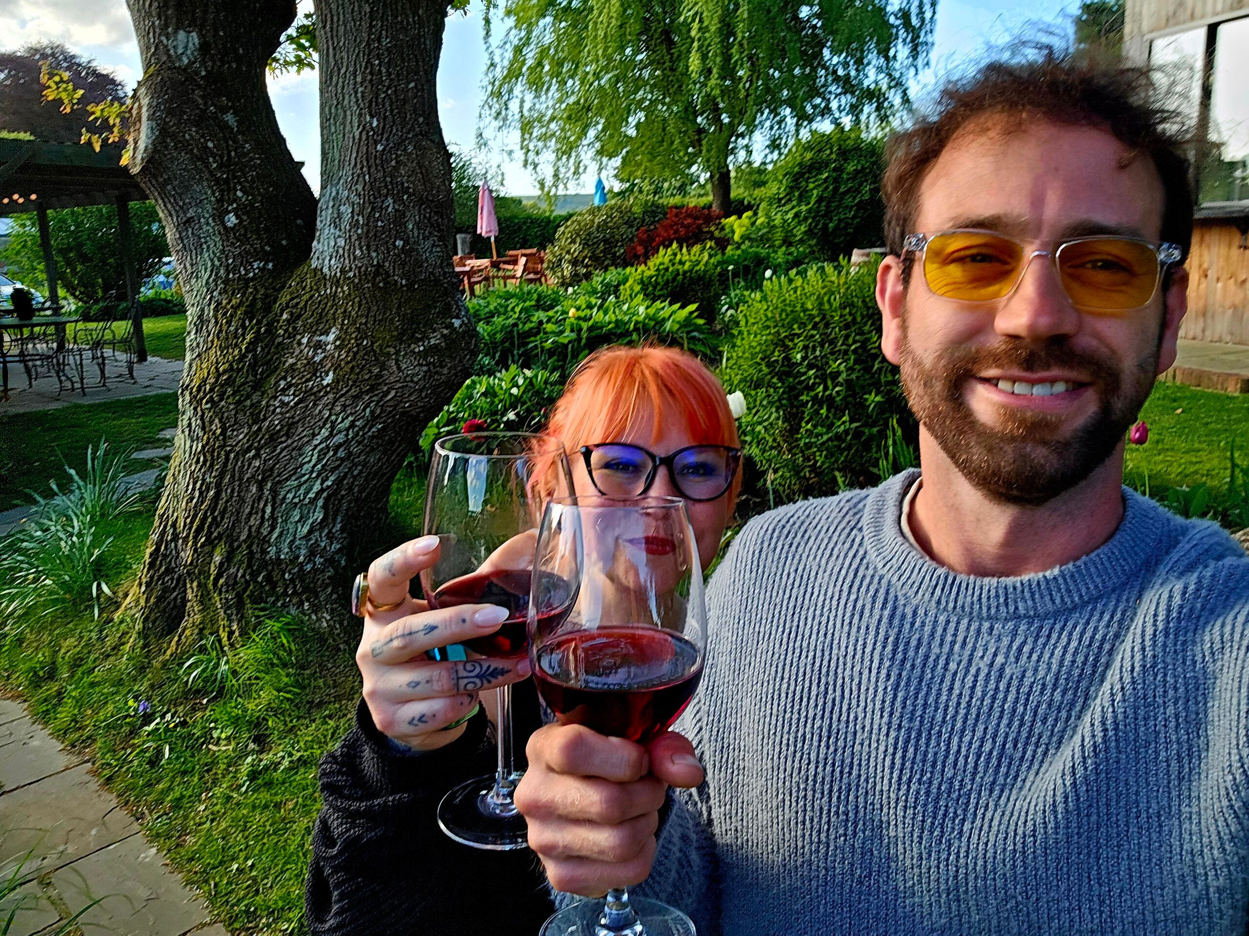 Jessica and her husband drinking a glass of red wine in the nature