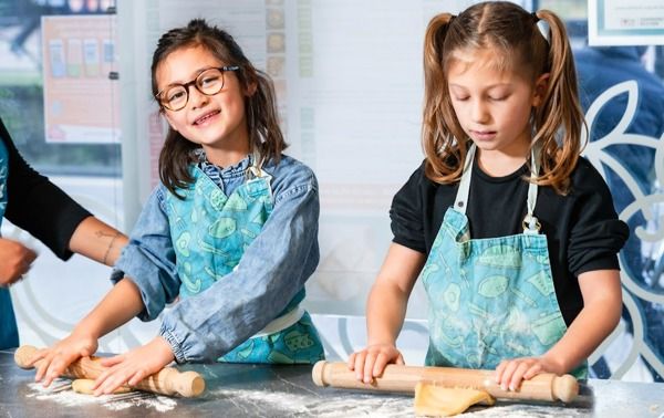 Two girls cooking at one of the cooking classes in Brighton