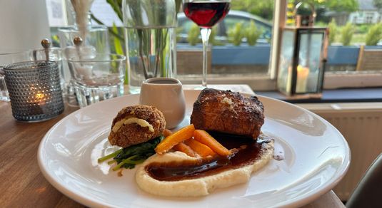 pork and belly served with glass of wine