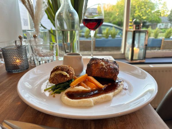 pork and belly served with glass of wine