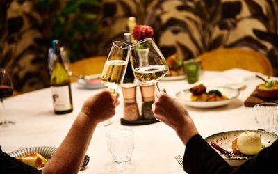 Wine in glasses being held up for a cheers in the private dining room at Terra.