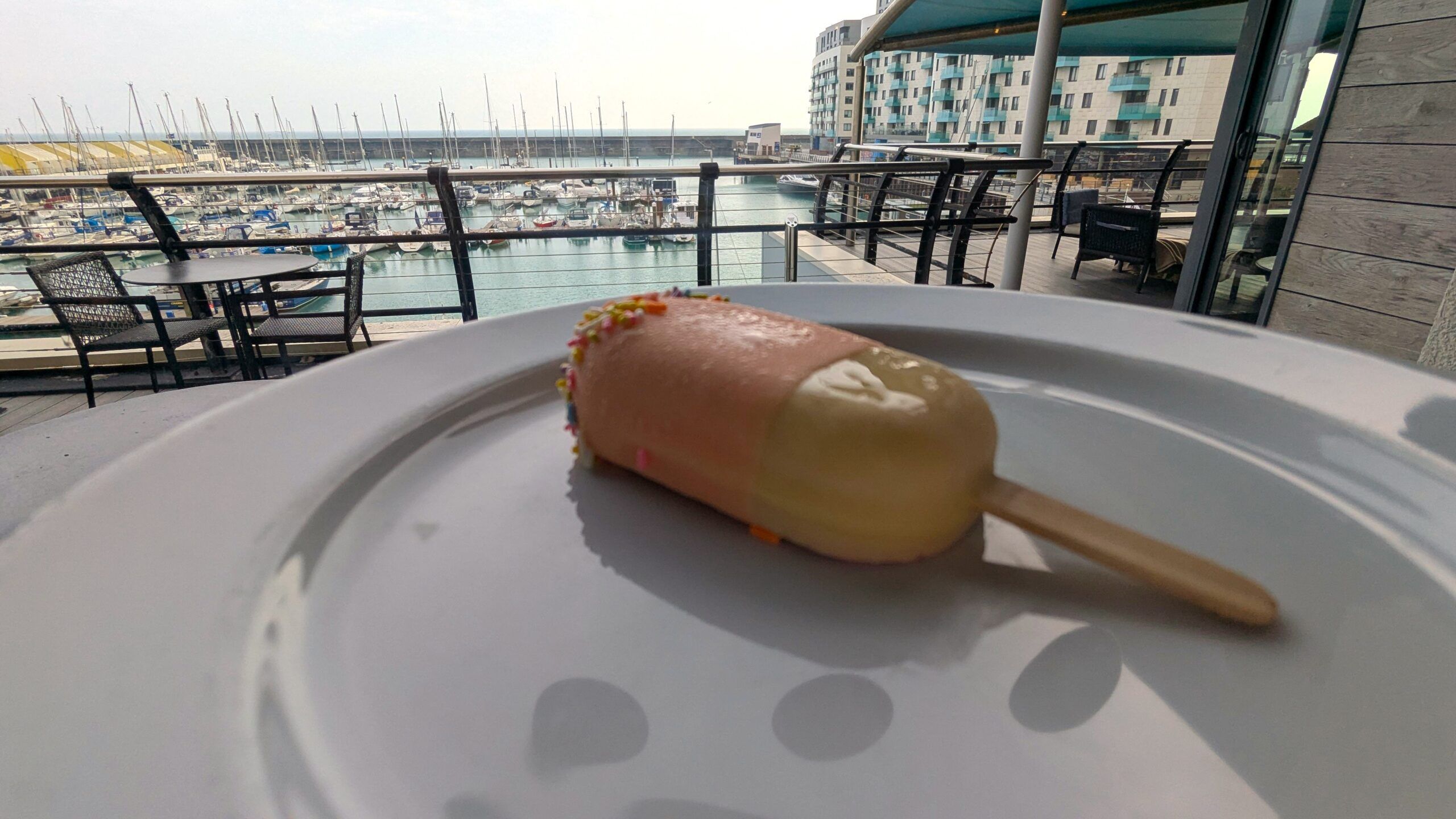 lolly dessert served on white plate on the window table looking at Brighton Marina. family afternoon tea Brighton