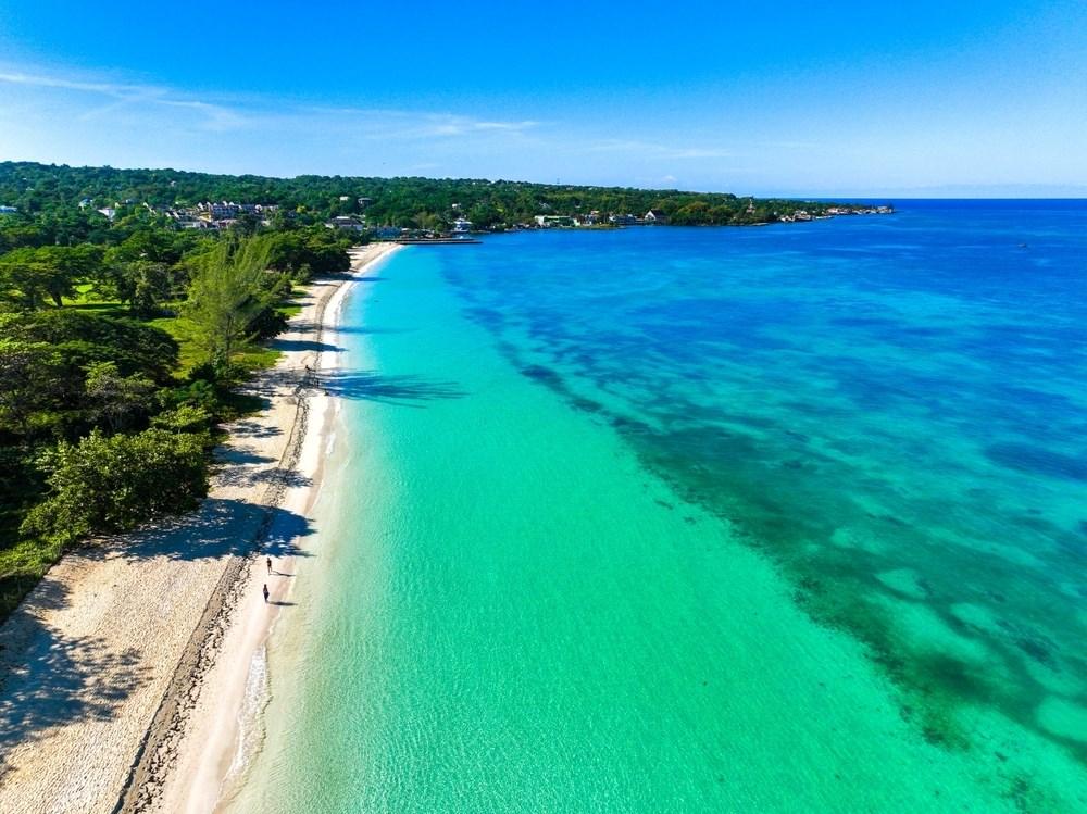 over head shot of the sandy beach and blue sea